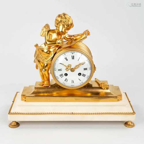 A mantle clock made of bronze on a white marble base and dec...