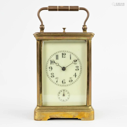 A vintage officers alarm clock, made of bronze glass and ena...