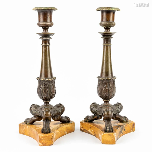 A pair of candlesticks made of bronze and mounted on an onyx...