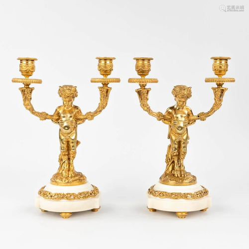 A pair of candelabra with Satyr figurines, made of gold-plat...