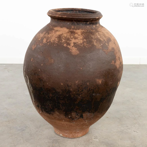 A large terracotta jar, probably made in Southern Europe. (6...