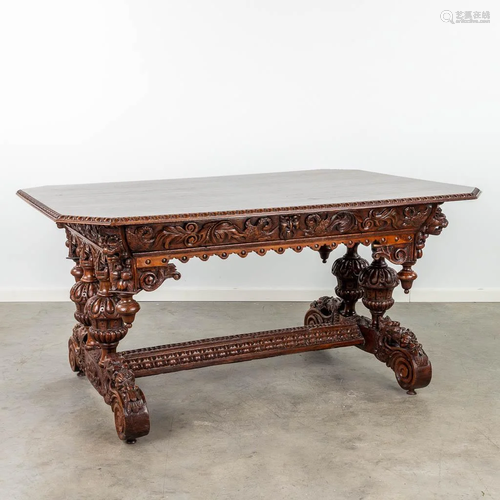 An antique desk made of sculptured oak with mythological fig...