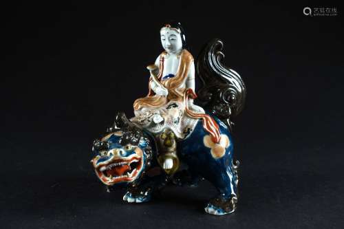 Guanyin chevauchant un lion de Fô. Statuette en porcelaine p...