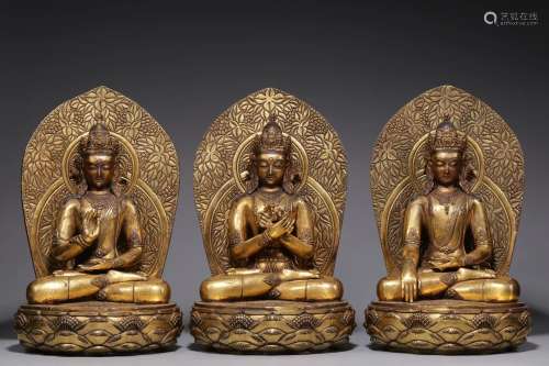 A group of seated statues of bronze gilded Buddha III in the...