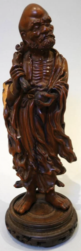 A wood carved figure of Arhat (Lohan). Chips on the hem.