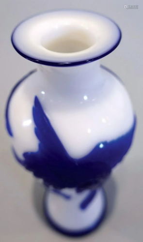 A blue overlay glass vase with pine and crane pattern . Late...