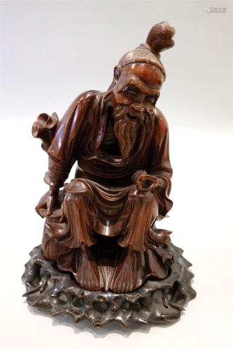 A wood carved fisherman figure, with the original wood carve...