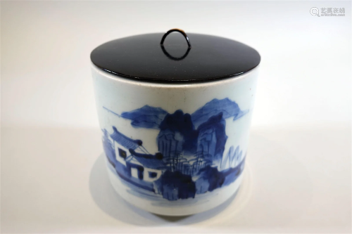 A blue and white brush pot with landscape painting and cover...
