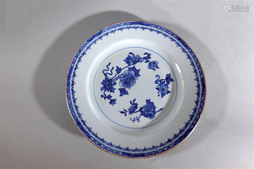 A blue and white flowers large plate with sauce glazed rim. ...