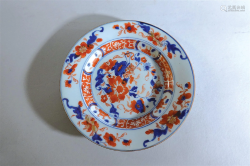 A blue and white and iron-red plate with flowers and landsca...