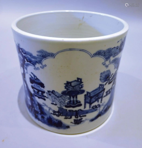 A large brush pot with blue and white lanscape and figures p...
