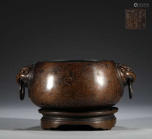 In the Qing Dynasty, the bronze double ear stove inlaid with...