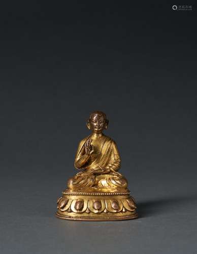 A TIBETAN GILT BRONZE FIGURE OF A MONK, 16TH CENTURY