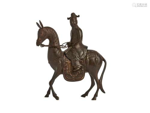 A BRONZE FIGURE OF AN OFFICAL RIDING A HORSE, LATE MING-EARL...