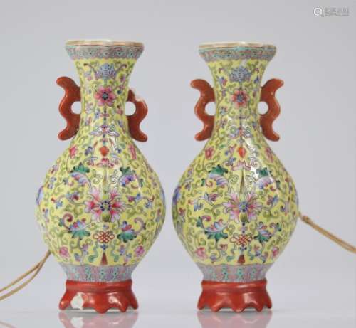 Pair of Chinese porcelain wall vases on a yellow background