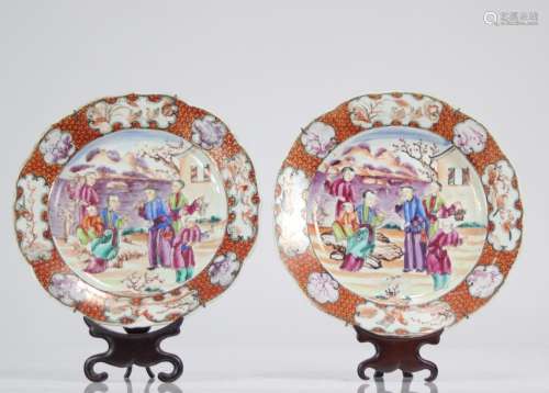 Pair of porcelain plates with Chinese plate holders
