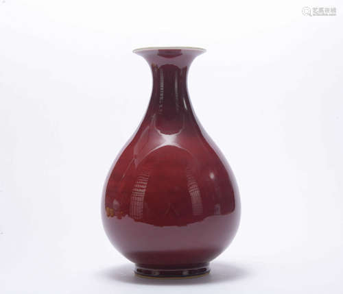 A red-glazed pear-shaped vase