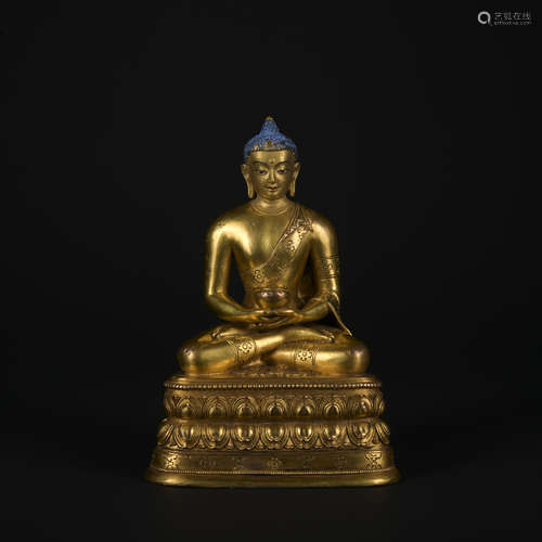 A gilt-bronze statue of Pharmacist Buddha