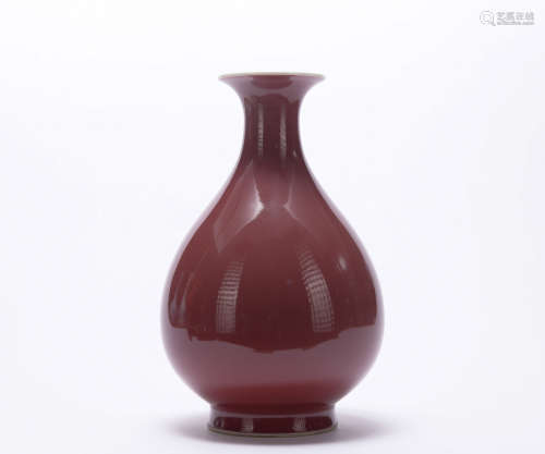 A red-glazed pear-shaped vase
