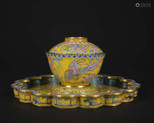 An enamel 'landscape' teacup and holder