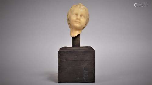 An Antique Wax Bust of a Young Boy, Mounted on a Wooden Plin...