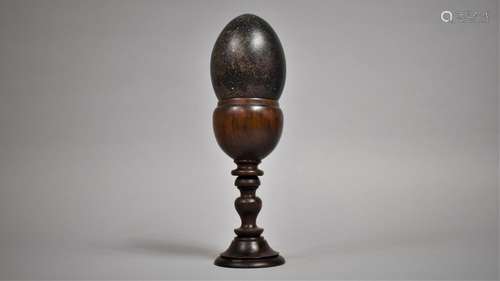 An Emu Egg Mounted on a Turned Wooden Stand. 30cms High