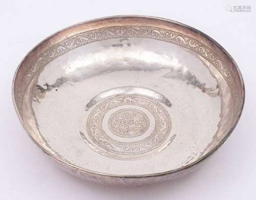 A Persian silver bowl: of beaten circular form,