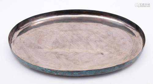 An Oriental silver tray: of plain oval form, raised on four ...