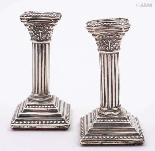 A pair of Edward VII silver miniature Corinthian column cand...