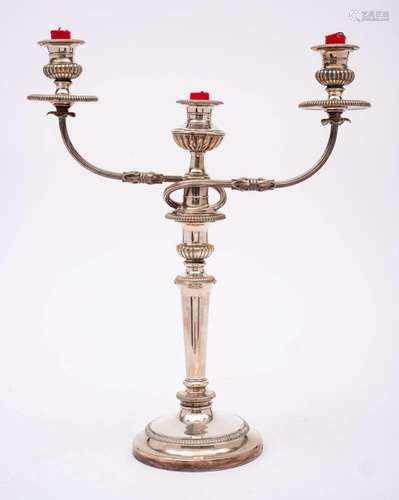 A plated twin branch candelabrum: with urn-shaped reeded sco...