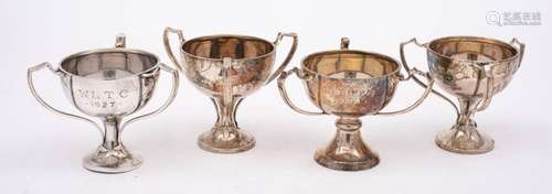 Four near matching triple handled trophy cups, maker Alexand...