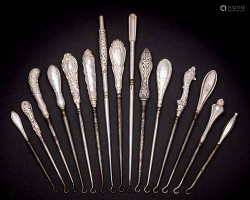 A collection of fifteen assorted silver-handled button hooks...