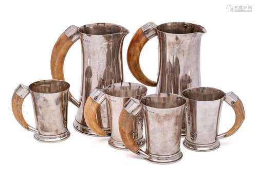 A matched set of silver beer jugs and mugs, maker Goldsmiths...