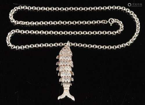 A silver fish pendant,: the articulated silver fish with cir...