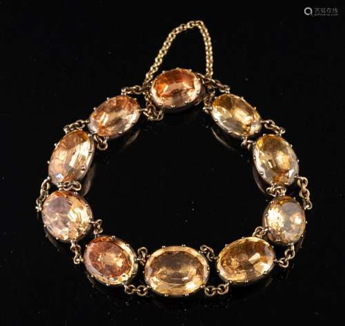 A foil backed topaz bracelet,: set with oval cut foil backed...