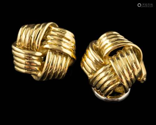 A pair of 18 carat gold knot ear clips,: stamped 750 with fu...