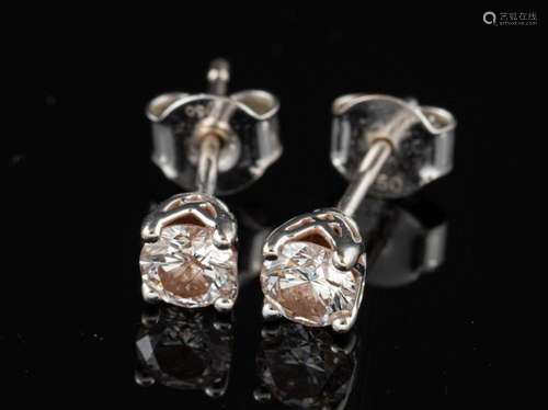 A pair of diamond ear studs,: the brilliant cut diamonds est...