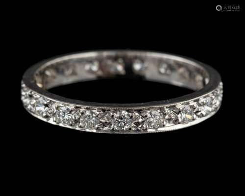 An 18 carat gold and diamond eternity ring,: set with brilli...