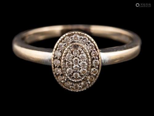 A diamond cluster ring: the oval panel set with brilliant cu...