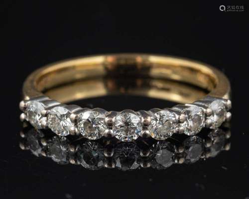 A diamond seven stone ring,: set with brilliant cut diamonds...