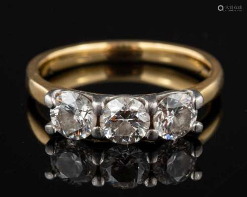 An 18 carat gold three stone diamond ring,: the three brilli...