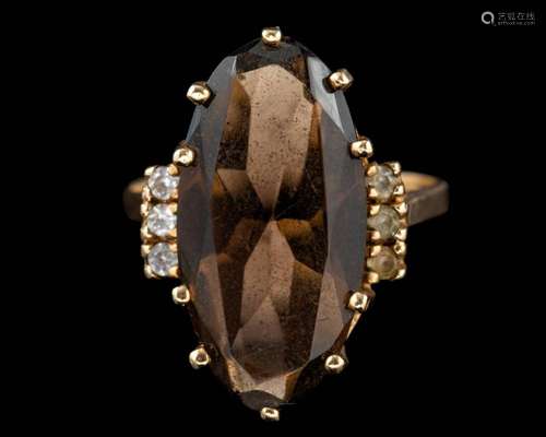 A smoky quartz ring,: set with a marquise cut smoky quartz, ...