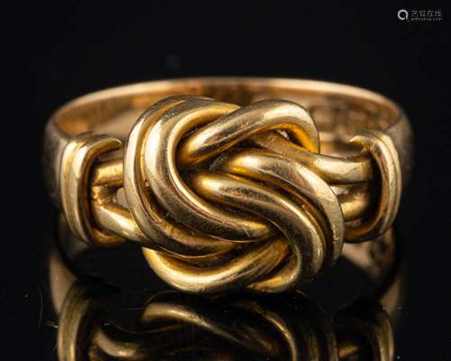 An 18 carat gold knot ring,: stamped 18 with full Birmingham...