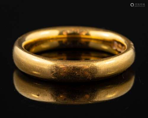 A 22 carat gold ring,: of plain polished form, stamped 22 wi...