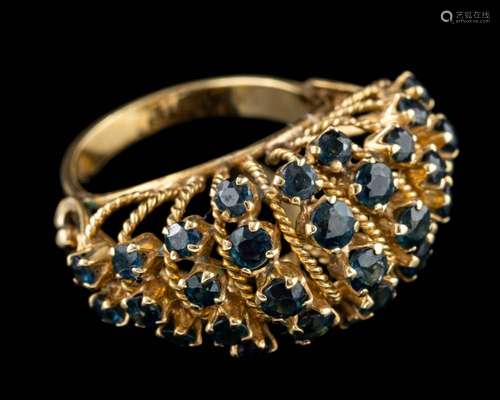 A sapphire ring,: the domed ring set with circular cut sapph...