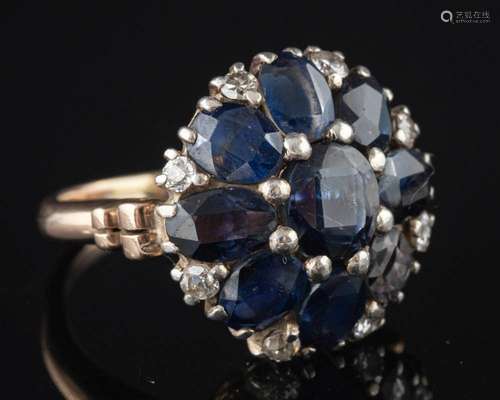 A sapphire and diamond cluster ring,: set with oval cut sapp...