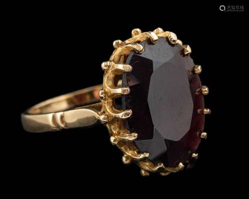 A 9 carat gold garnet ring,: the oval cut garnet in a claw s...