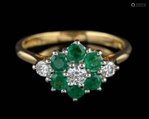 An 18 carat gold emerald and diamond ring,