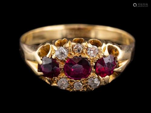 An 18 carat gold ruby and diamond ring,: the three oval cut ...