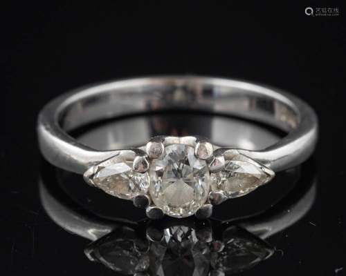 A diamond three stone ring,: the oval cut diamond estimated ...